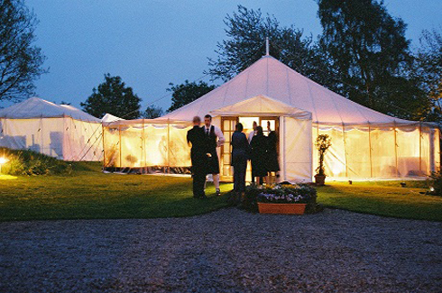 Traditional marquees fit well against older buildings in Scotland